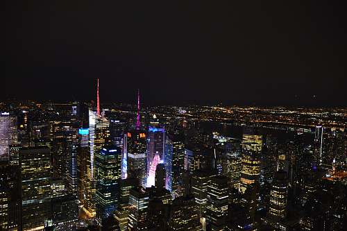 city aerial photo of city buildings at night building